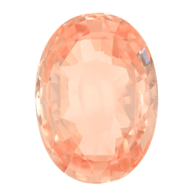 Oval padparadscha sapphire gemstone close-up with peach-orange facets