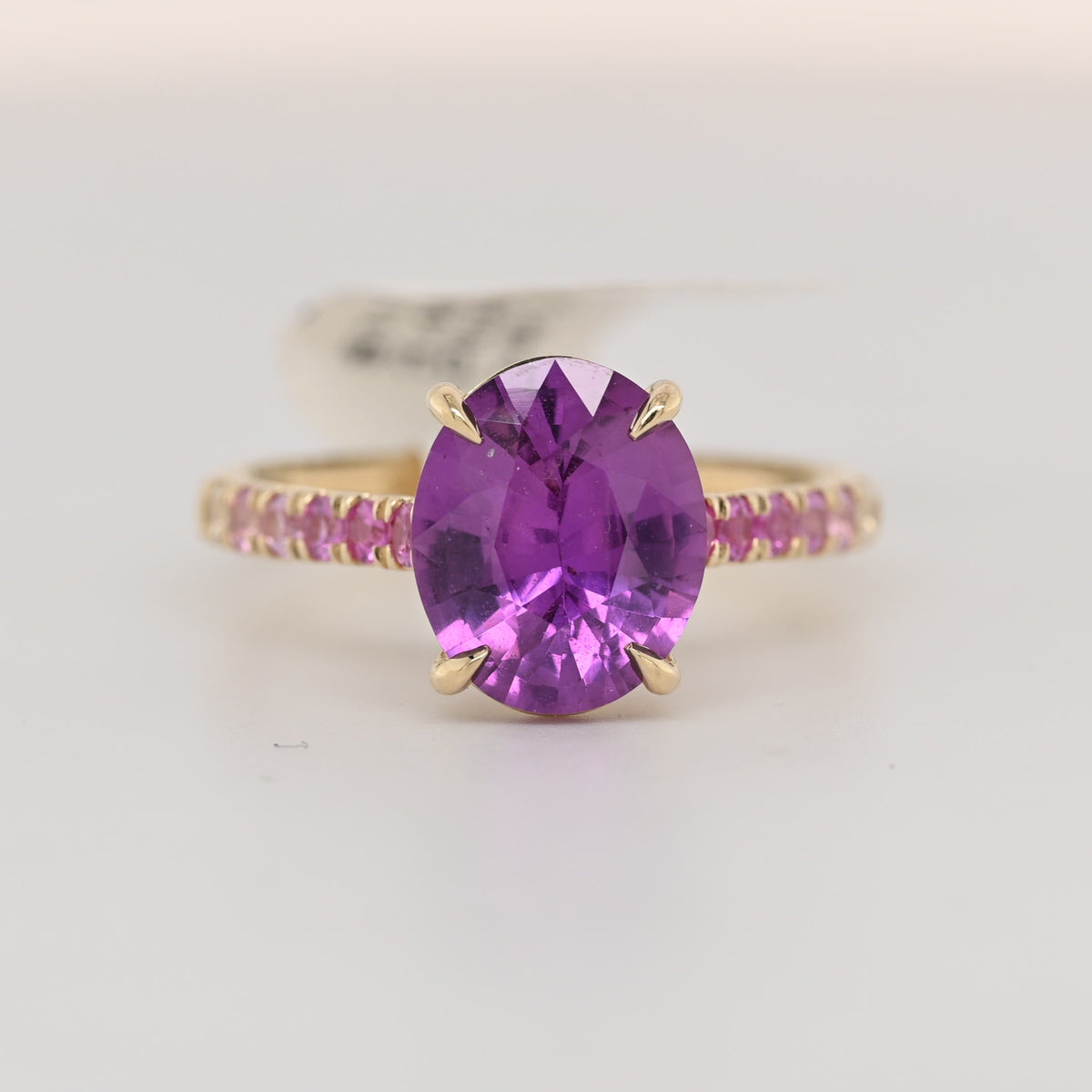14k yellow gold sapphire ring with oval purple gemstone and jeweled band