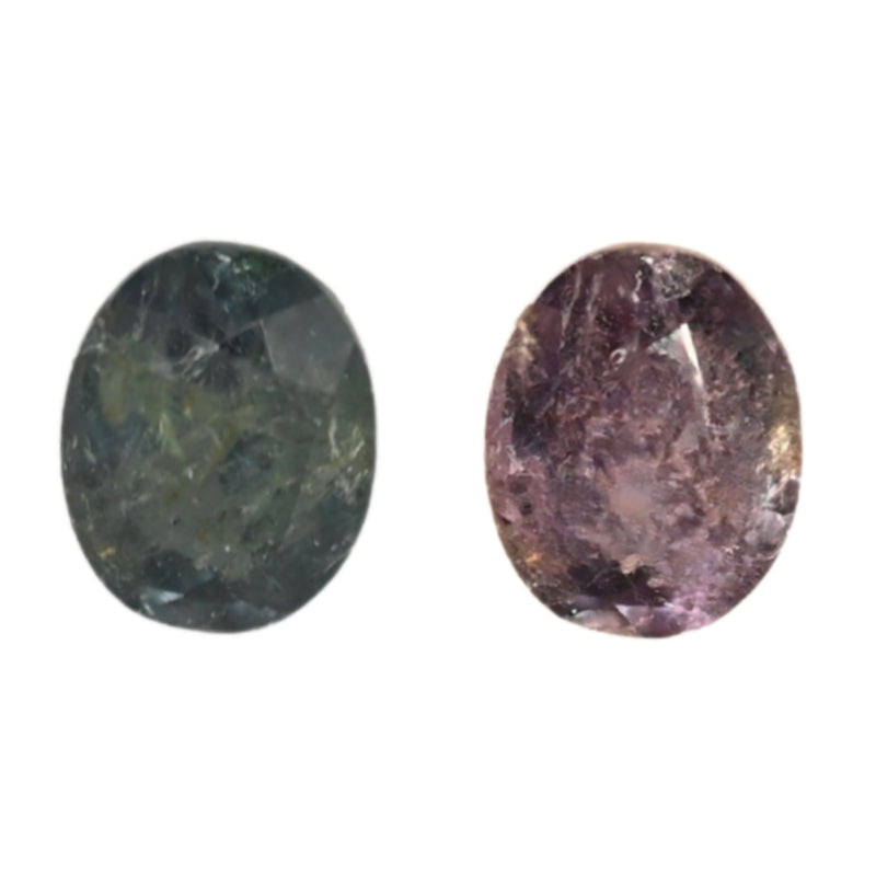 Close-up oval alexandrite gemstones: dark green and deep purple facets