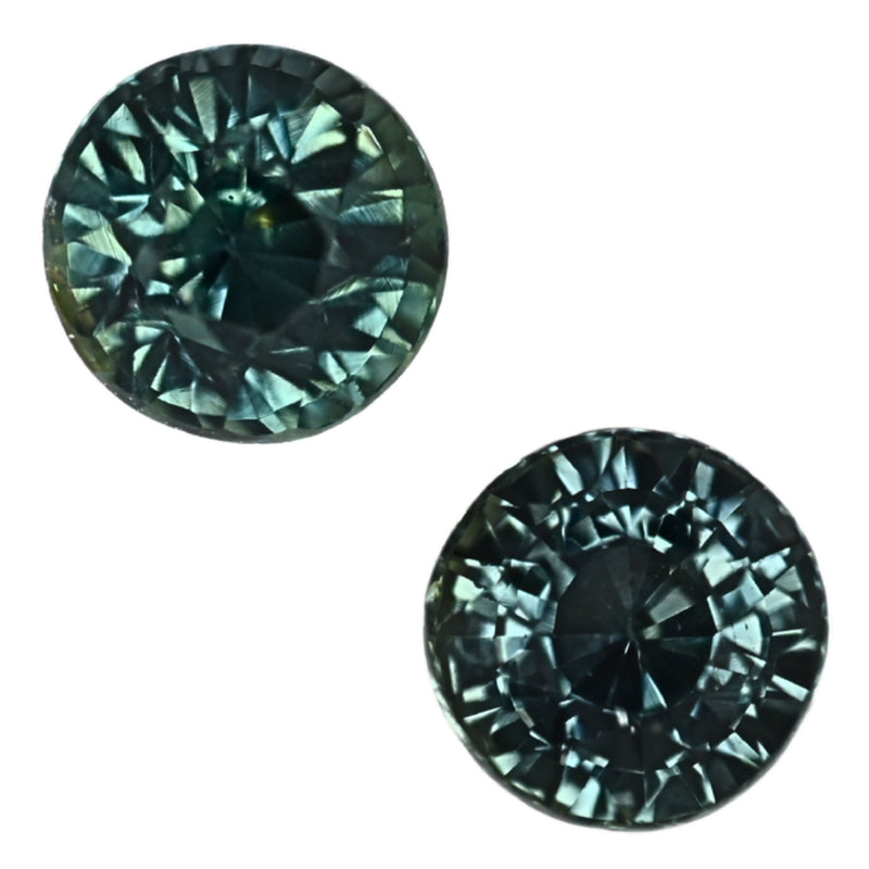 Pair of round teal sapphire gemstones, faceted