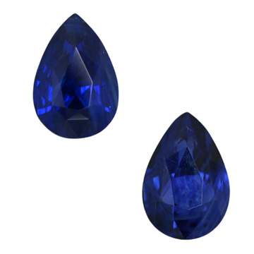 Pair of pear-cut blue sapphire gemstones with faceted surfaces
