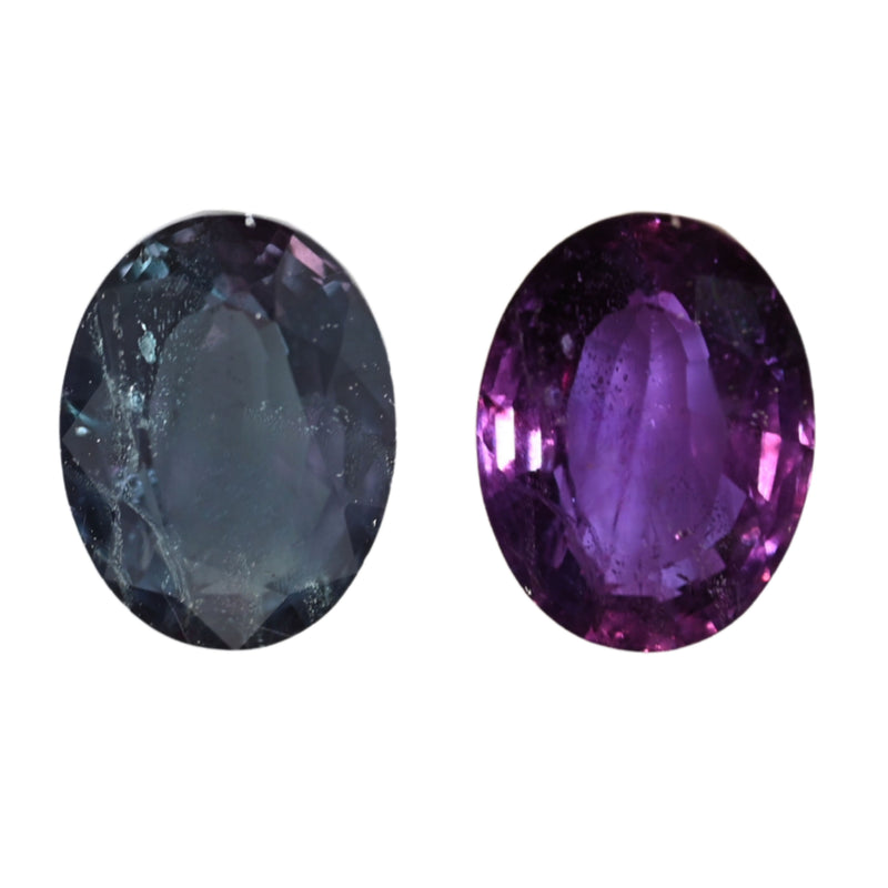 Two oval alexandrite gemstones, left blue-gray and right vivid purple