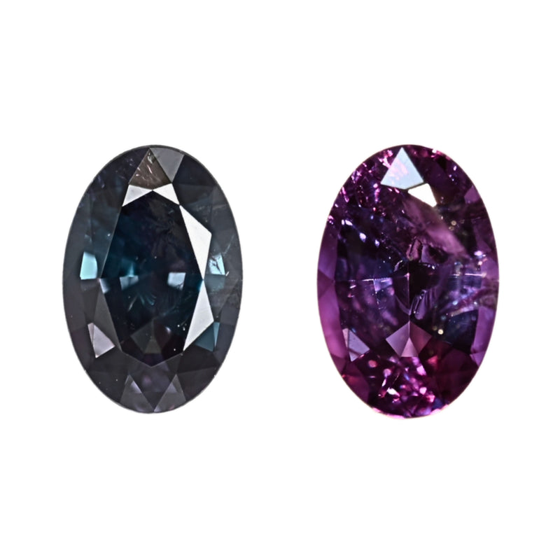 Two oval alexandrite gemstones on white, one dark teal, one purple