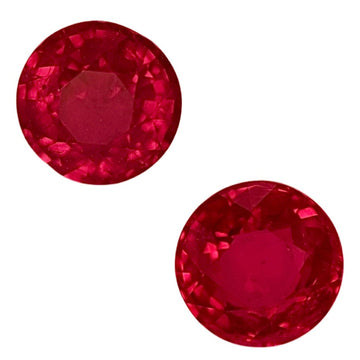 Pair of round ruby gemstones, faceted red with a bright sparkle