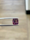 2.45ct purple cushion-cut spinel gemstone in tweezers
