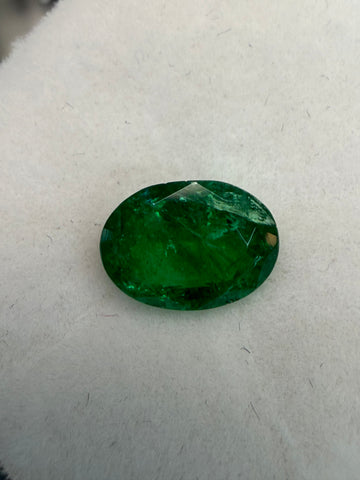 Oval-cut green emerald gemstone, faceted stone close-up view