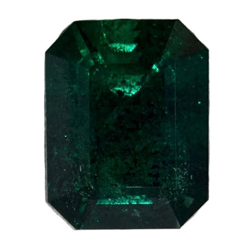 Emerald-cut green gemstone with dark green octagonal step facets