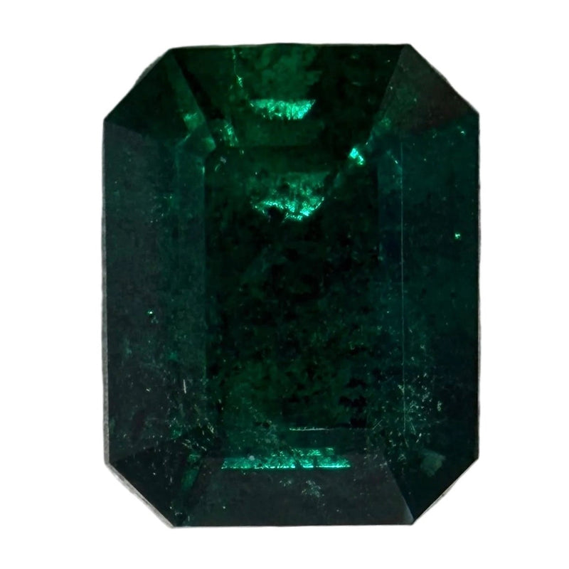 Emerald-cut green gemstone with dark green octagonal step facets