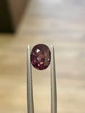 Oval maroon-purple spinel gemstone in open prong setting with metal rails