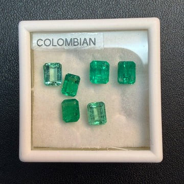 Mixed emerald gemstone box with six green square and rectangle cuts