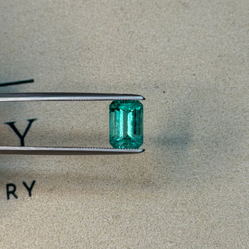 2.33-carat emerald-cut green gemstone on metal prongs