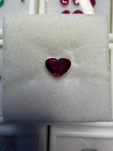 1.09-carat heart-shaped ruby gemstone, deep red, on display cushion