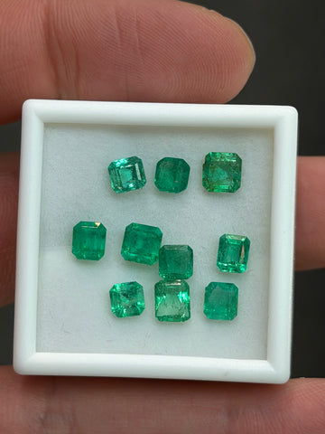 Emerald gemstone set in white presentation box, green square-cut stones