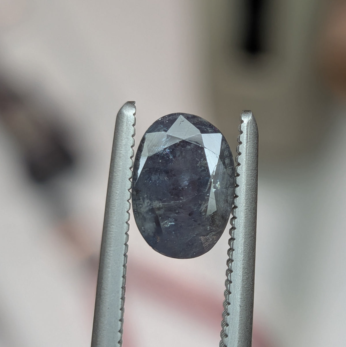 1.16ct alexandrite gemstone, oval dark blue stone in two-prong metal setting