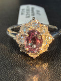 Alexandrite halo ring with purple-red oval center and sparkling diamond halo