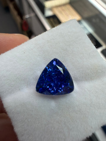 4.00-carat triangular blue tanzanite gemstone with faceted cut on display