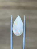 3.27-carat white opal teardrop cabochon between metal prongs
