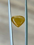 Faceted yellow-brown diamond in display tray, close-up