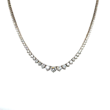 Graduated diamond necklace with prong-set stones in a sparkling tennis-style curve