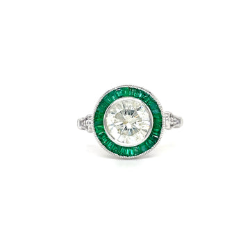 Round diamond ring in 14k white gold with emerald halo and small side stones