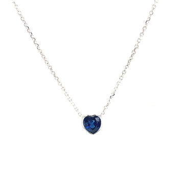 Heart-shaped blue sapphire pendant on 14k white gold chain, close-up