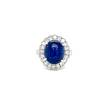 Platinum ring with diamond halo around blue round star sapphire center stone