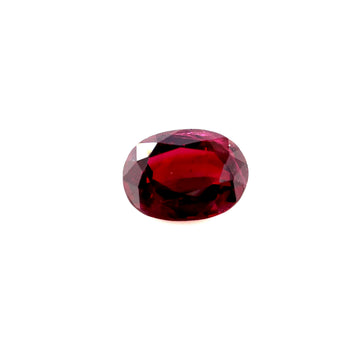 Oval dark red ruby gemstone on white background