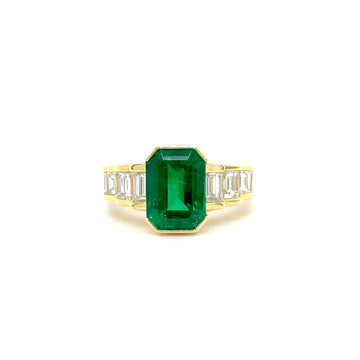 18k yellow gold ring with emerald-cut green emerald center and baguette diamond side stones