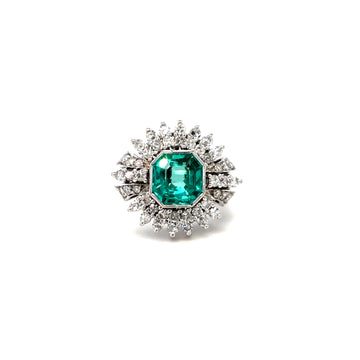 Platinum ring with emerald-cut green center stone and diamond halo