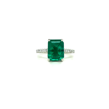Square green emerald centerpiece with diamond halo and slim pave band