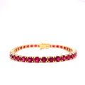 Ruby tennis bracelet with prong-set round red gemstones in gold-tone links