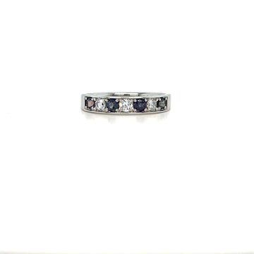 Silver-tone eternity ring with square-cut diamonds and dark blue stones across top.