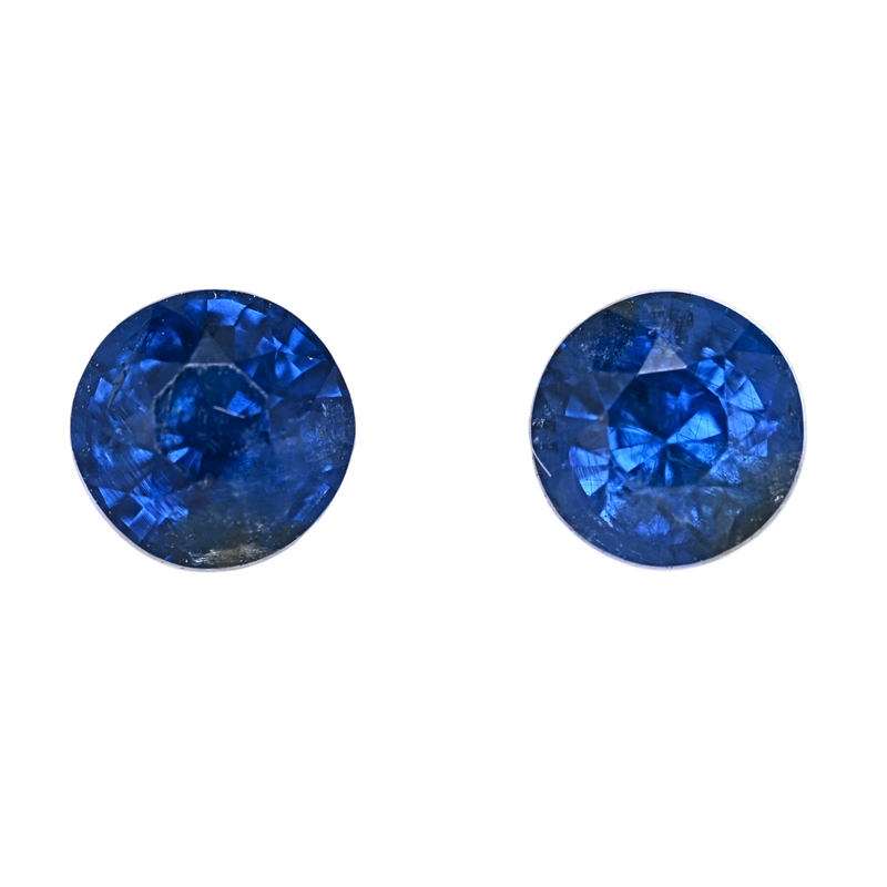 Pair of oval blue spinel gemstones, faceted with a rich blue sparkle.