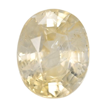 Oval yellow sapphire gemstone, faceted, polished surface close-up