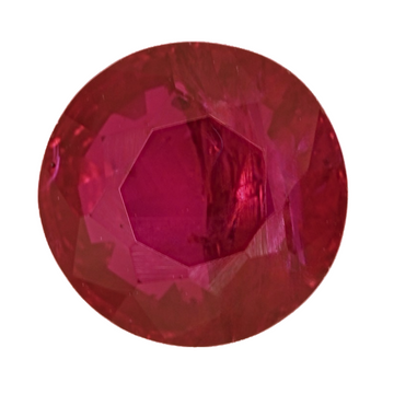 Oval faceted ruby gemstone close-up, magenta-red facets