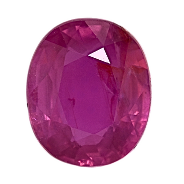 Close-up oval faceted ruby gemstone with visible facets, vivid pink-red