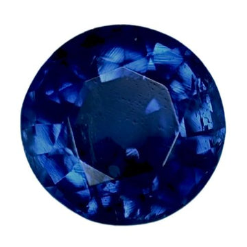 Round blue sapphire gemstone, faceted with deep royal-blue color