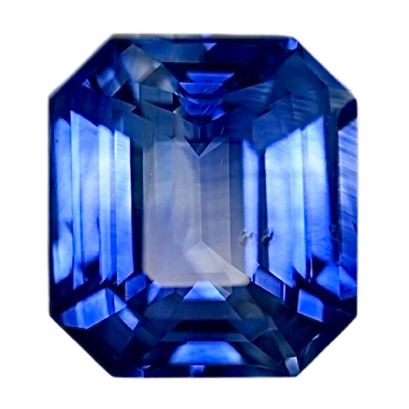 Bi-color sapphire gemstone, emerald-cut with deep blue and light blue facets