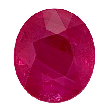 Round ruby gemstone with faceted surface, deep red color