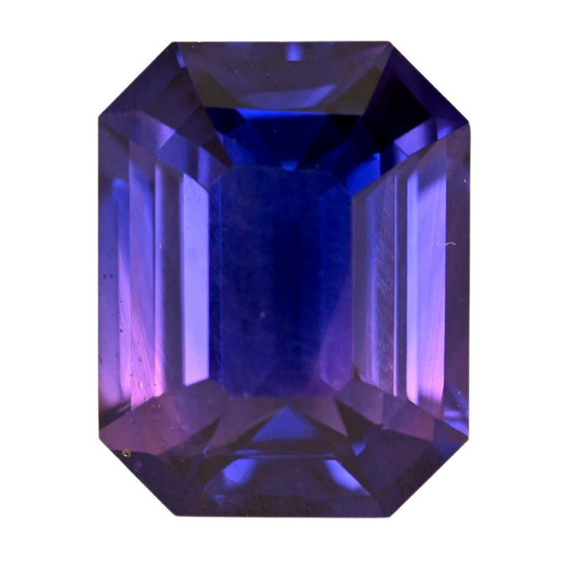 Octagon cut sapphire gemstone with blue-purple tones, polished facets.