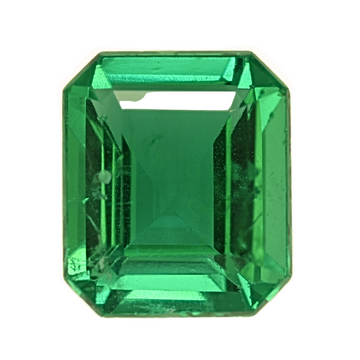 Emerald gemstone close-up, emerald-cut vivid green with crisp facet edges