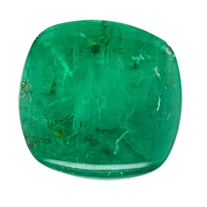 Green cushion-cut emerald gemstone with a polished face and visible natural inclusions.