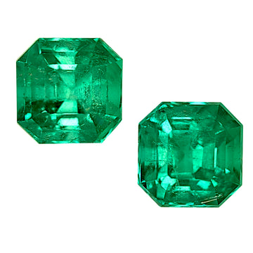 Pair of green emerald-cut gemstones with faceted octagon shapes