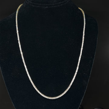 Diamond tennis necklace with round stones, curved slender chain.