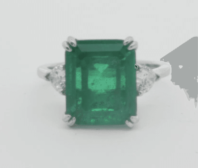 Silver ring with emerald-green square center stone and halo prongs